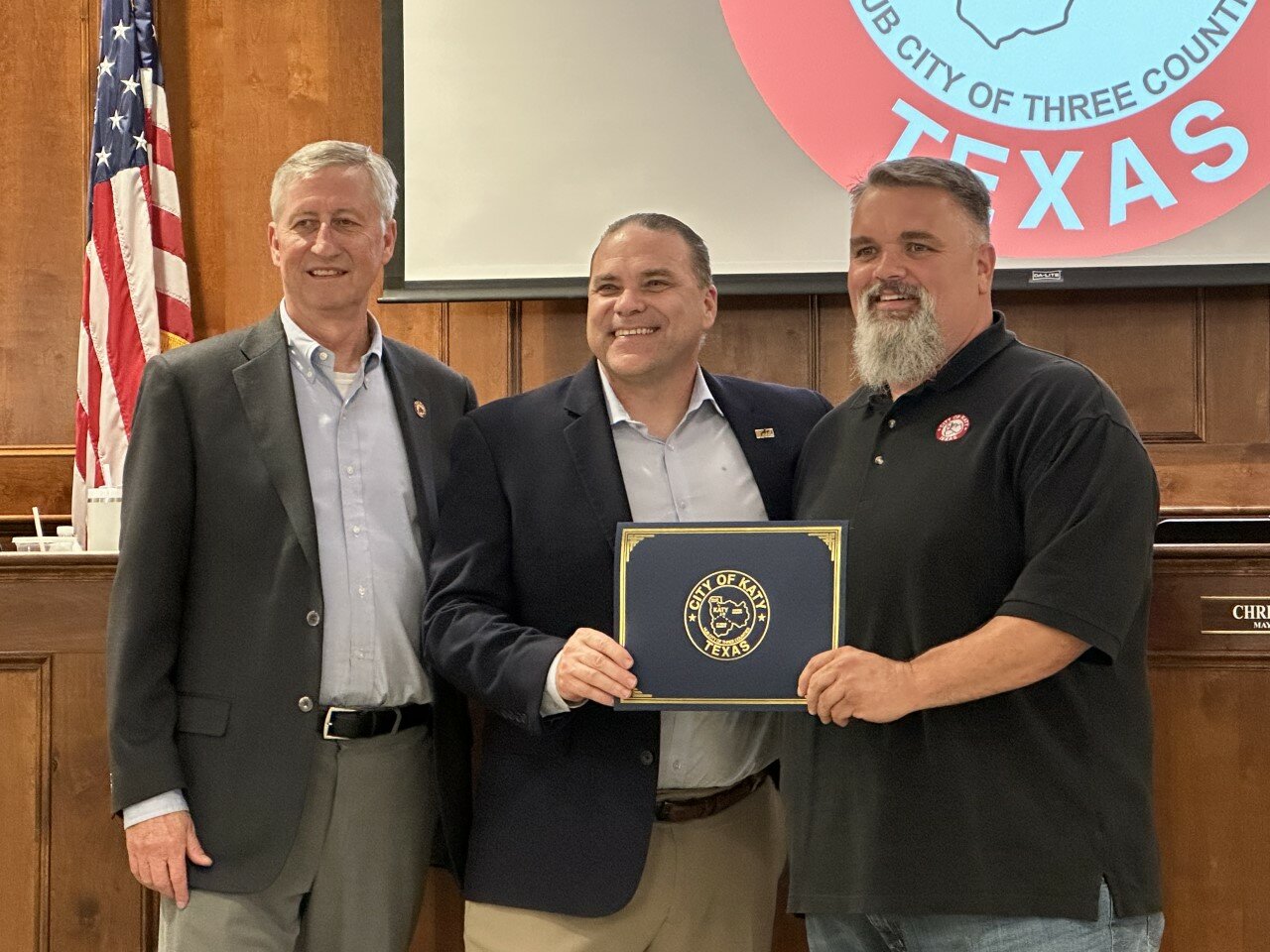 Katy ISD superintendent Ken Gregorski, center, accepts a proclamation from Mayor Dusty Thiele, left, and Ward B Council Member Rory Robertson in recognition of Teacher Appreciation Week.